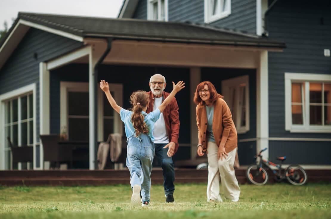 little girl running towards grandparents