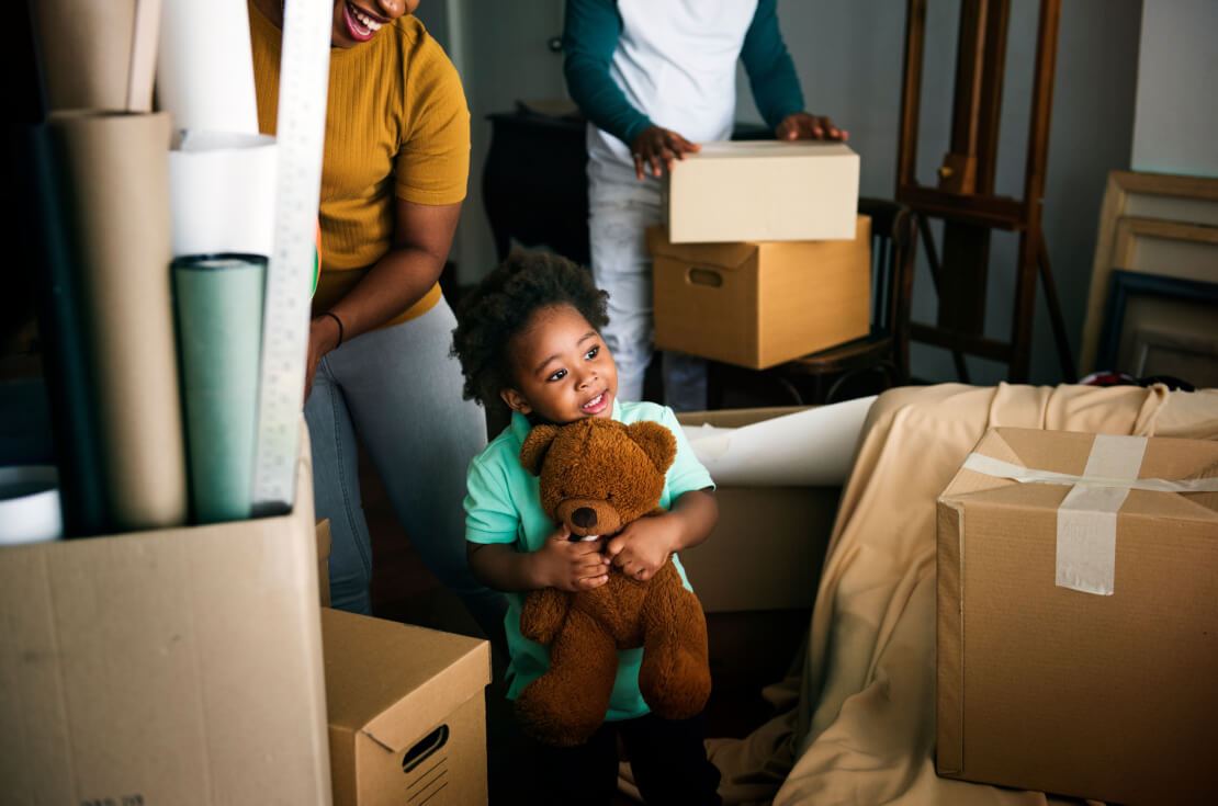 little boy with teddy bear during move