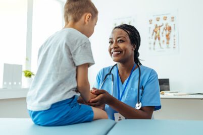 woman nurse with little boy at appointment