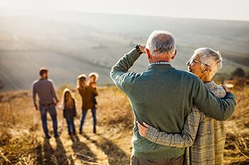 older couple looking at younger family