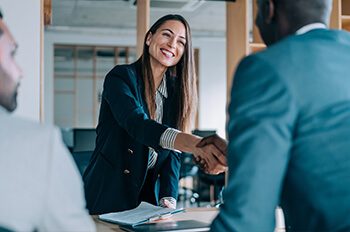 woman shaking hands in meeting